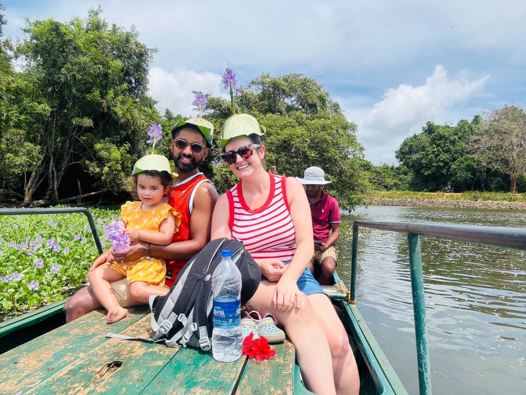 Family wearing lotus leaf hats during a boat ride in Sri Lanka with Olanka Tours