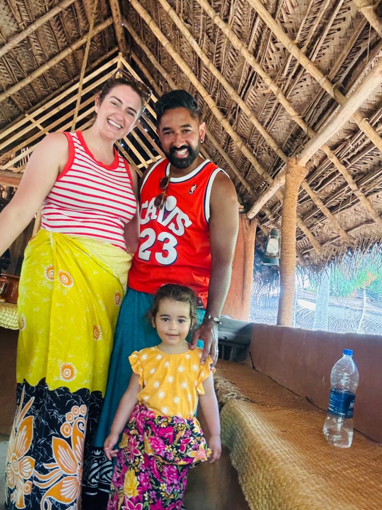 Family wearing traditional Sri Lankan clothes inside a village home with Olanka Tours